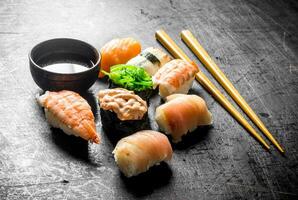 Different sushi with soy sauce and chopsticks. photo