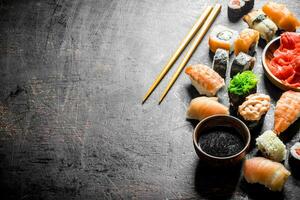 Different sushi with soy sauce and chopsticks. photo