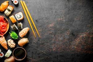 Pieces of delicious Japanese sushi and rolls with soy sauce. photo