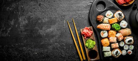 Set of different kinds of sushi rolls with salmon, shrimp and vegetables. photo