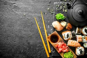 Sushi rolls with shrimp and salmon on a stone Board. photo