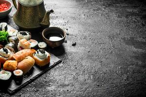 Different sushi rolls with soy sauce. photo