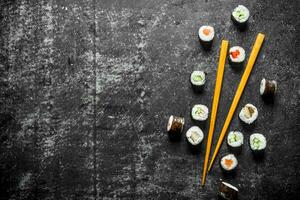 Sushi maki with chopsticks. photo