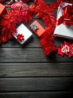 Various Christmas boxes with tinsel and decorations. photo