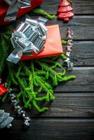 Red Christmas boxes with fir branches and streamers. photo