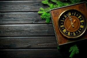 Retro Christmas clock with fir branches. photo