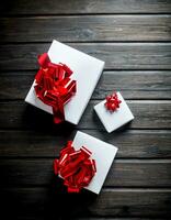 White Christmas gift boxes with red bows. photo