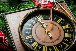 New year's clock on the spruce branches. photo