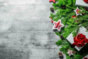 White gift box with Christmas decorations and fir branches. photo