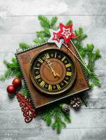 Christmas retro clock with fir branches. photo