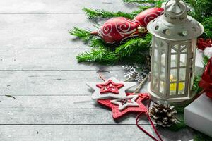 Old candlestick with Christmas decorations and fir branches. photo