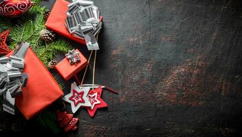 Gift boxes with Christmas decorations and fir branches. photo