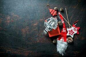 Red gift box with Christmas decorations and cones. photo
