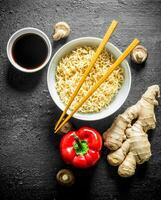 Instant noodles in bowl with bell pepper, ginger and soy sauce. photo