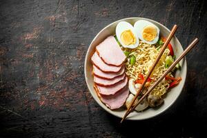 Instant noodles with vegetables, egg, mushrooms and slices of becon. photo