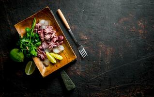 Baby octopus with lime and greens. photo