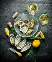 Raw oysters in a colander with white wine, lemon and dill. photo