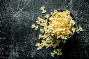 Dry pasta Farfalle in the bowl. photo