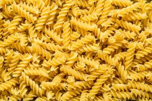 Pasta background. Dry pasta fusilli. photo