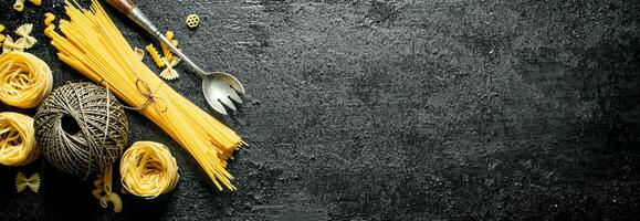 Dry pasta tagliatelle and spaghetti with twine. photo