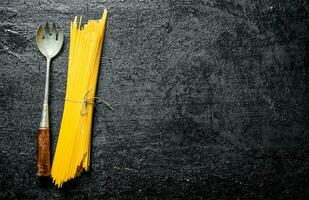 Dry spaghetti with ladle. photo