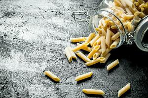 Dry pasta in a glass jar. photo