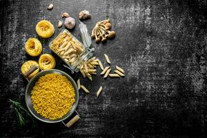 Different types of raw paste in a jar and a colander with mushrooms and garlic. photo