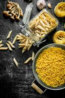 Different types of raw paste in a jar and a colander with mushrooms and garlic. photo