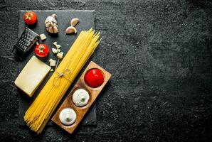 Raw spaghetti with Parmesan and different sauces. photo