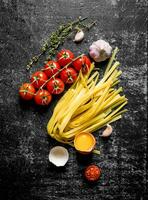 Home made raw pasta with egg, tomatoes and thyme. photo