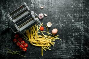 Preparation of homemade raw pasta with tomatoes and thyme. photo