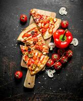 Slices of Mexican pizza with bell peppers and tomatoes. photo