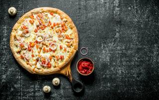 Pizza with chicken and cheese sauce. photo