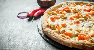 Pizza with chicken and cheese sauce. photo