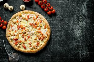 Pizza with tomatoes, chicken and cheese. photo