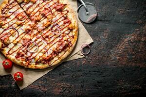 Barbecue pizza with bacon, chicken and sauce. photo