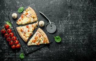 Chicken pizza slices and cherry tomatoes. photo