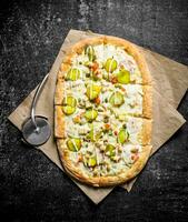 Vegetable pizza on paper. photo