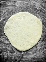 Rolled out pizza dough. photo