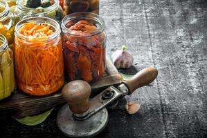 Jars of various preserved food on tray. photo