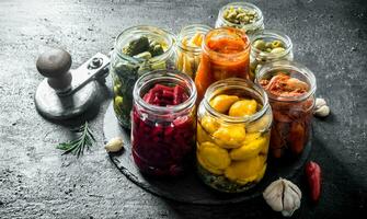 Pickled vegetables in glass jars. photo