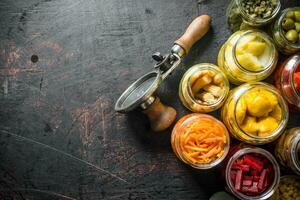 Pickled vegetables in glass jars. photo