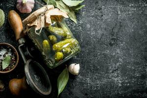 Preserved cucumbers with spices, Bay leaves and garlic. photo