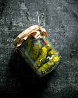 Pickles in a glass jar. photo