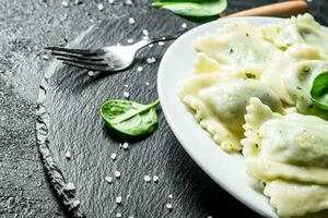 Ravioli with spinach leaves. photo