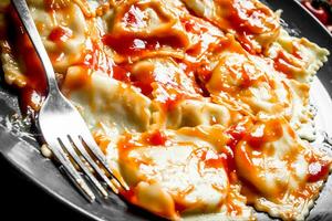 Italian ravioli with tomato sauce. photo