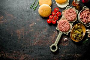 Raw burgers with jalapeno chillies, tomatoes and scones. photo