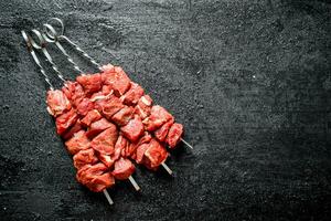 Skewers of raw shish kebab. photo