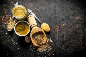 Mustard in a jar, scoop and bowl. photo