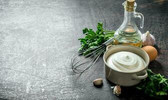 Mayonnaise with herbs, oil and garlic. photo